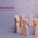 circle of wooden figures and learnovate logo